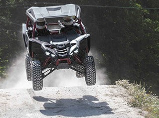 ATV, lifting off a hump in the terrain